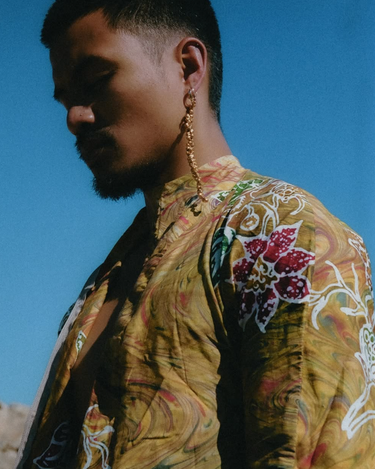 Model is wearing gold peppercorn earring